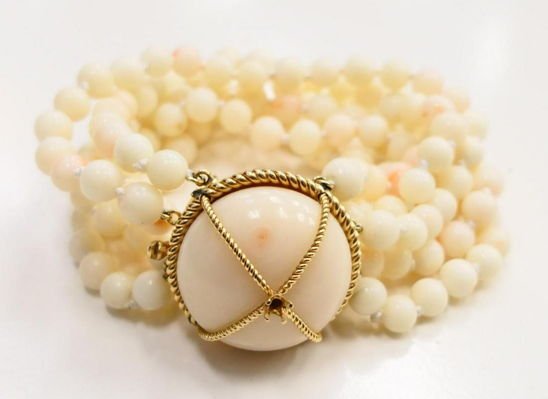 WHITE CORAL AND HEAVY 14KT Y GOLD LADIES BRACELET: About 7" long. 3 Strand of white and angel skin coral with heavy 14kt yellow gold clasp. Big round dome carved of white coral. The top has a small round brilliant diamond. . Property of a Miami Beach