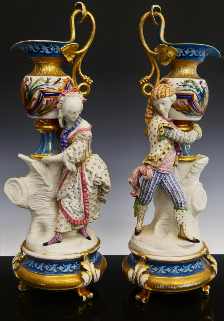 CIRCA 1800 JACOB PETIT FINE FRENCH BISCUIT URNS: A pair of early 19th century, circa 1800, attributed to Jacob Petit, fine French bisque and porcelain figural urns depicting a man and woman with pitchers atop tree stumps. Wonderfully crafted and pai