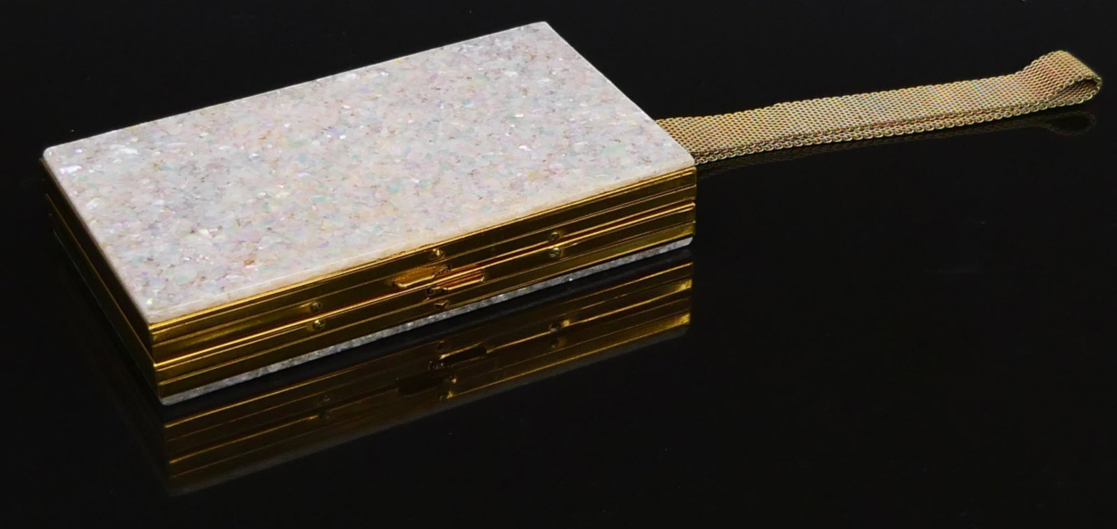 VINTAGE GOLD TONE MOP CARRYALL CLUTCH PURSE: Vintage rectangular carry all vanity clutch purse having a gold tone metal design with mother of pearl exterior. Includes Bakelite comb. Measures approx. 5 1/2" length x 3 1/8" width x 1" depth (14cm 