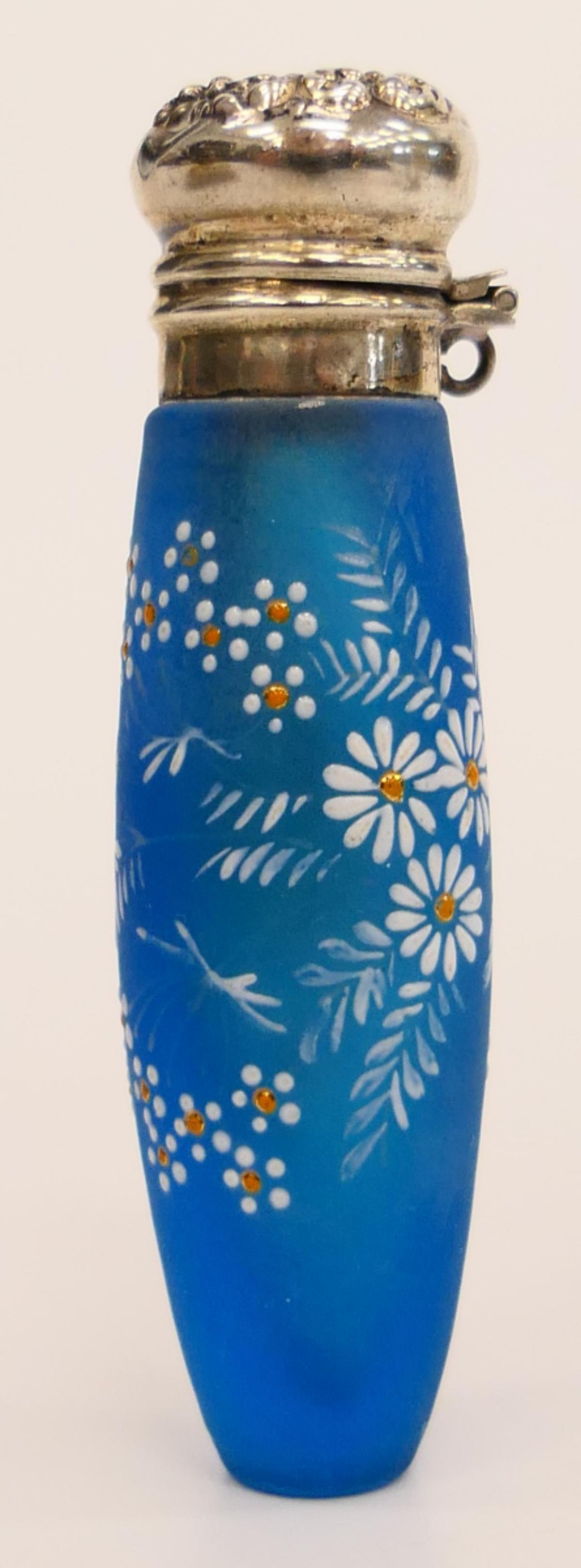 THOMAS WEBB CAMEO GLASS PERFUME BOTTLE: Measures about 3" tall, with silver mounting. Daisy decoration. Blue satin glass bottle. Third party shipping required.
