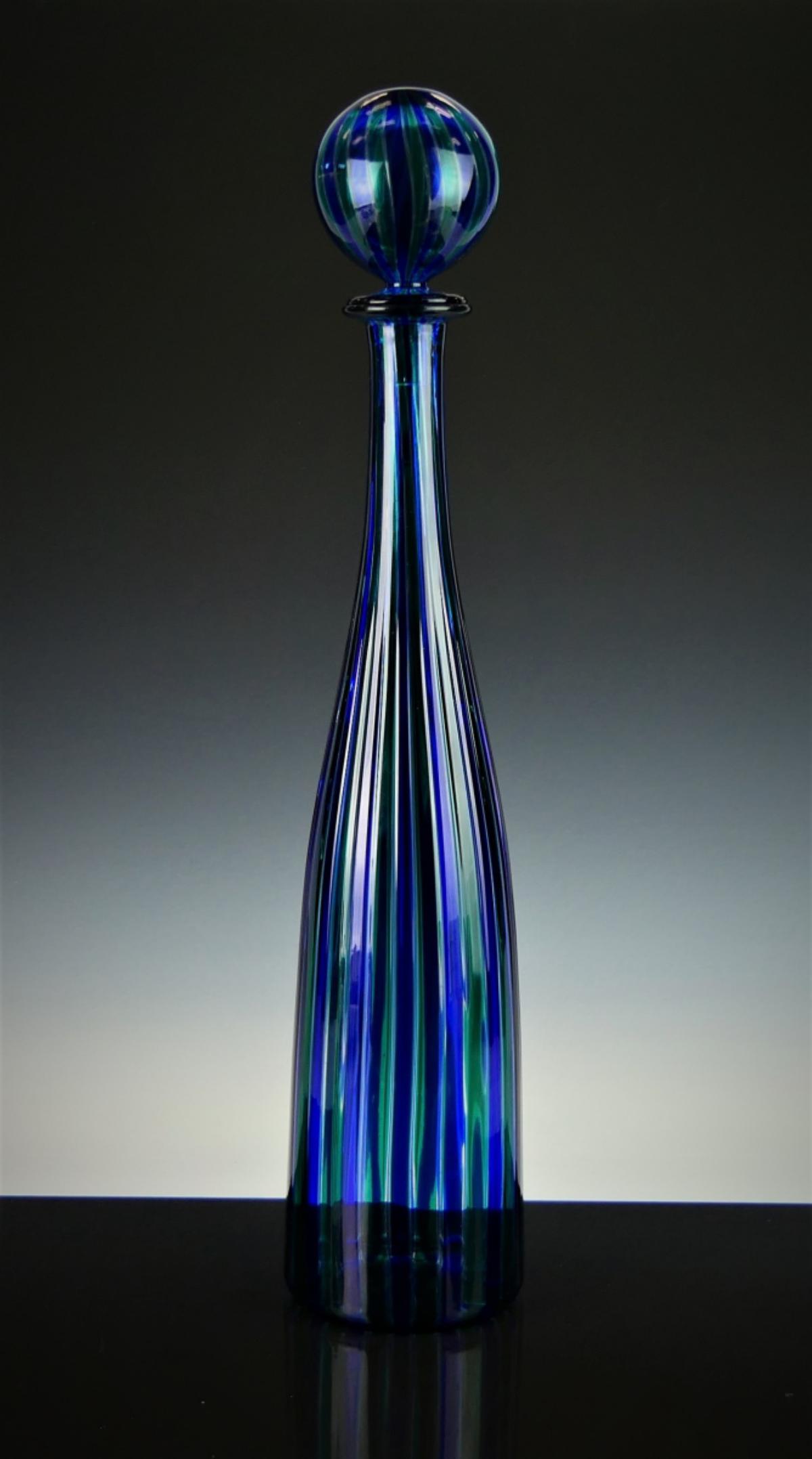 VENINI MURANO GIO PONTI STRIPED ART GLASS DECANTER: Attributed to Gio Ponti (ITALIAN, 1891 - 1979), a Venini Murano Italian Canne art glass decanter with ball stopper having turquoise and cobalt blue tone vertical stripes with clear handle. Dremel sign