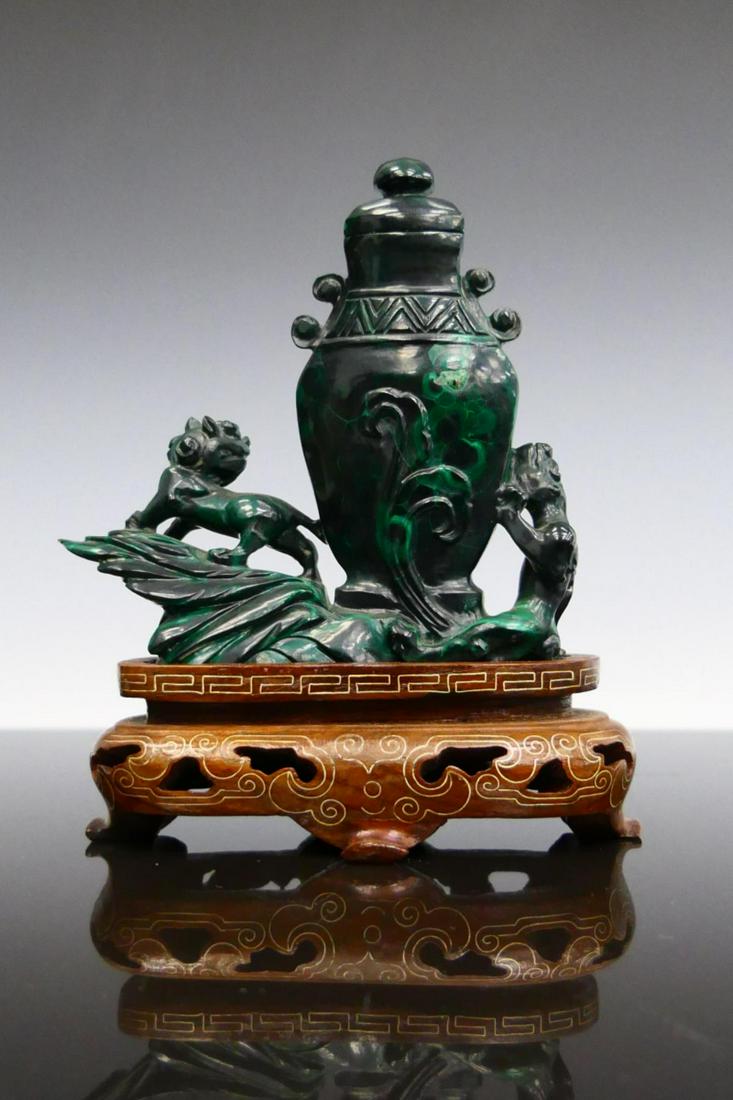 CHINESE CARVED MALACHITE FOO LIONS CABINET VASE: Chinese carved malachite stone covered cabinet vase urn having a foo lions design. Includes fitted silver inlay wooden display stand. Measures approx. 4 7/8" height (12.4cm) overall including base. To