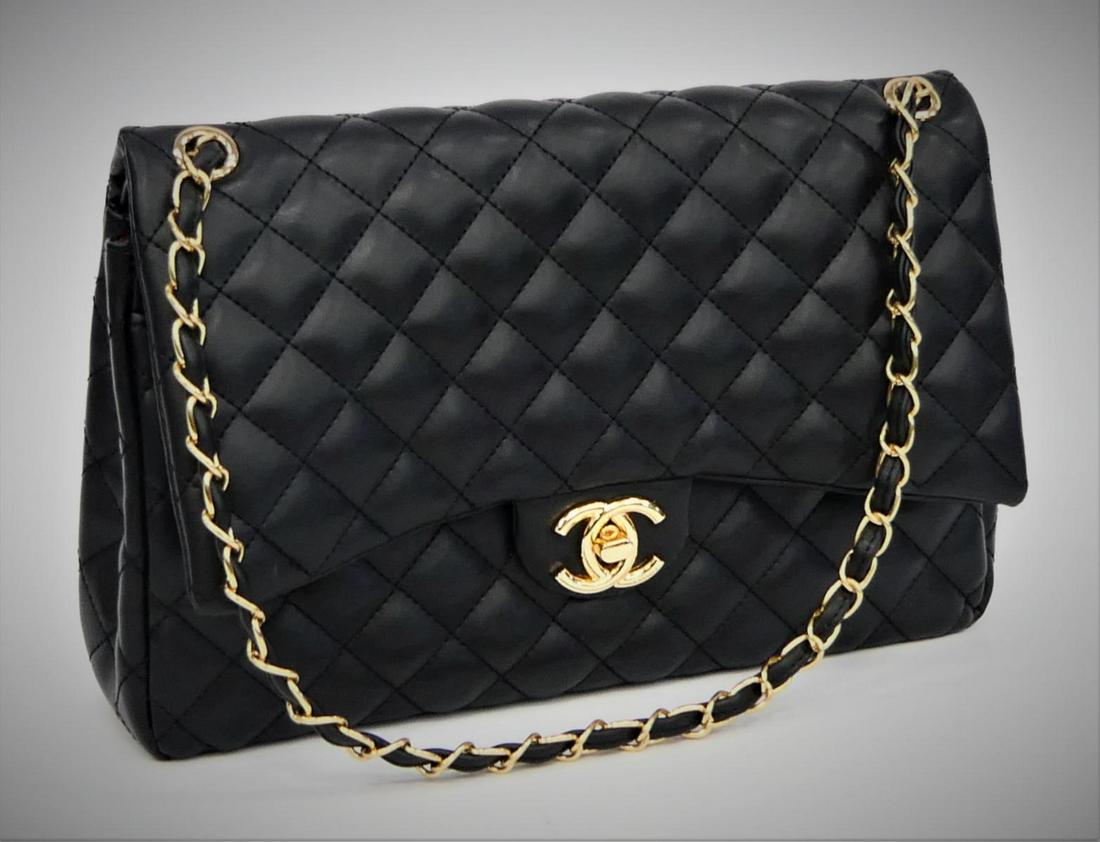 CHANEL CAVIAR BLACK LADIES HAND BAG: Measures 12" wide and 7 1/2" tall. Has gold and matching leather strap. ( NOTE: WE ARE NOT EXPERTS, THIS BAG IS NOT GAURENTEED TO BE AUTHENTIC. PLEASE BID ACCORDINGLY.)