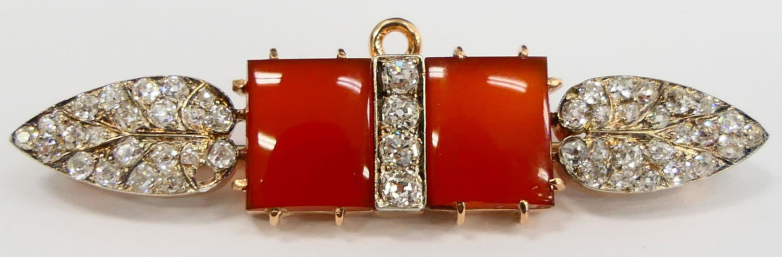 RARE TIFFANY & CO 14 KT ROSE GOLD & DIAMOND BROOCH: Measures just over 2" long , with 2 square carnelian inserts. 56 round brilliant top quality diamonds. Diamonds total about 1 ct. total weight 9.42 grams/ 6 DWT