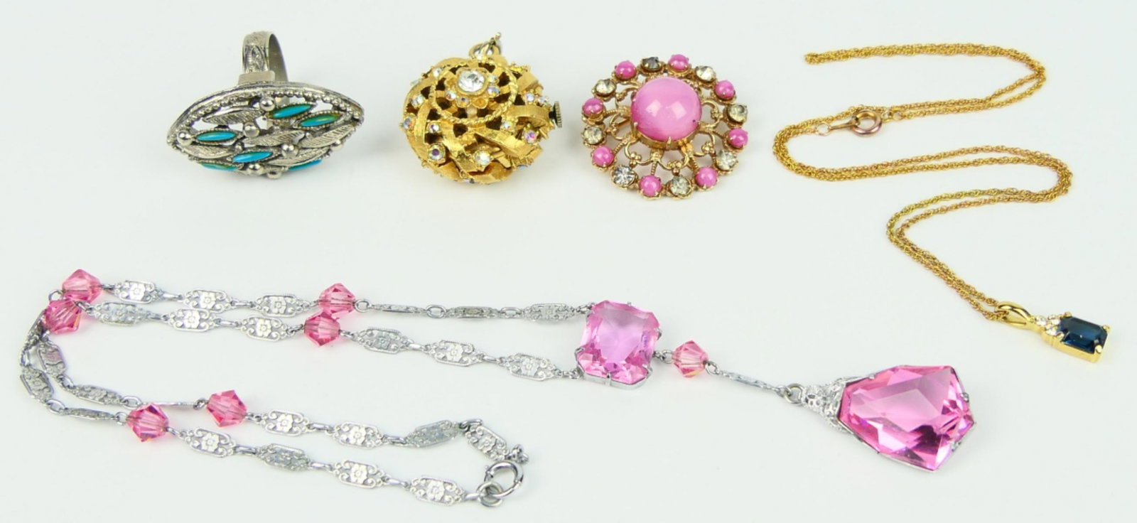 LOVELY LOT OF VINTAGE COSTUME JEWELRY: To include; Corea necklace, vintage hanging watch, Necklace with faux pink tourmaline, Navajo style ring, and pink moonstone ring