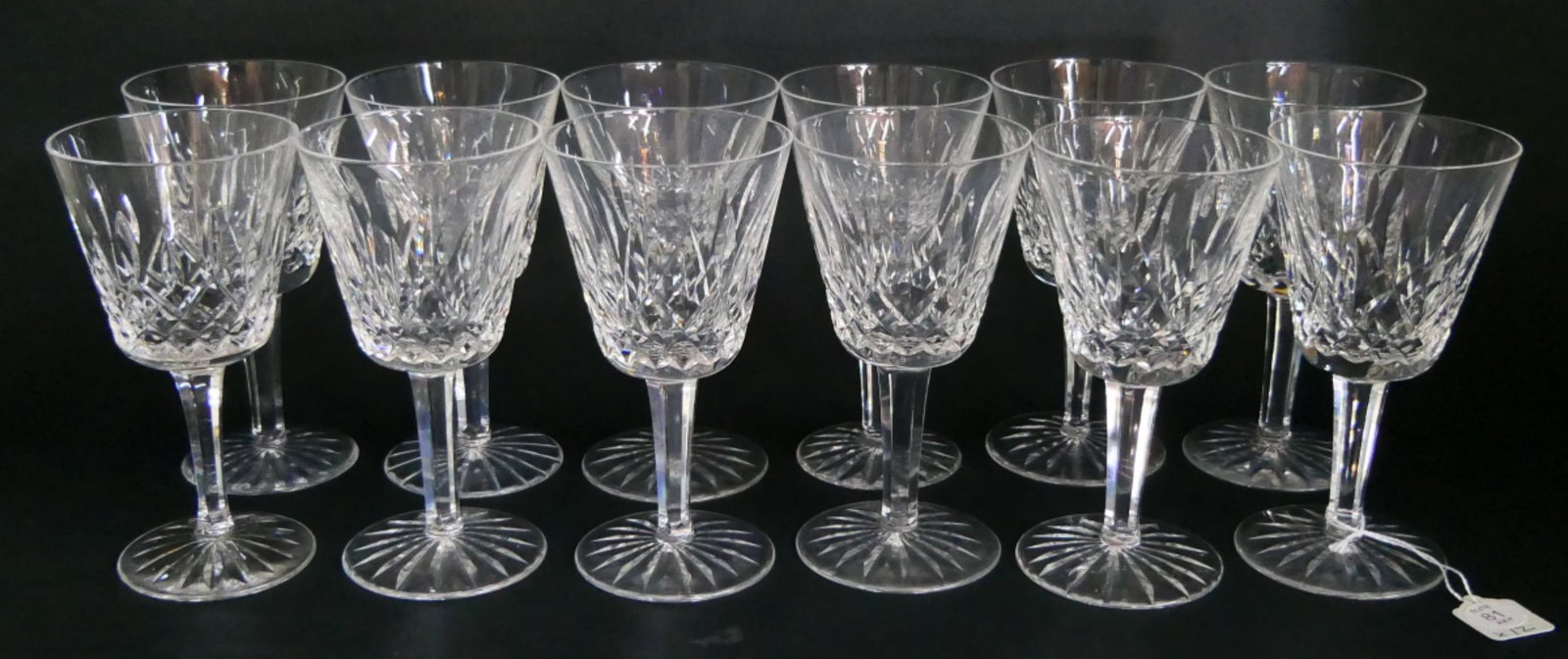 12 WATERFORD "LISMORE" CLARET WINE GLASSES: A set of 12 Waterford Irish cut crystal claret wine stemware glasses in the "Lismore" pattern. Each with acid Watermark to bottoms. Each measures approx. 5 7/8" height x 3 1/8" diameter (14.9cm x 7.9c
