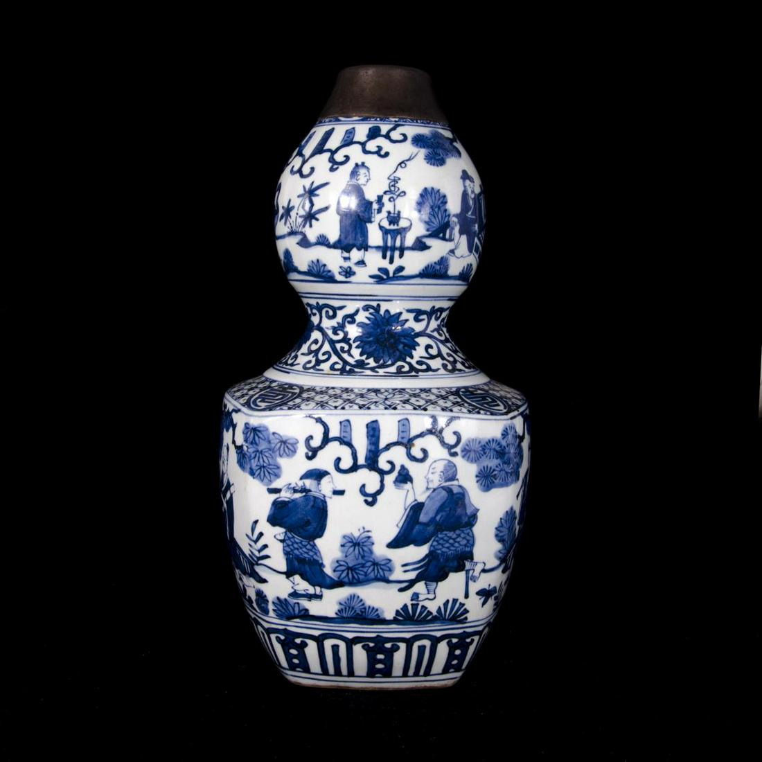 CHINESE BLUE & WHITE PORCELAIN HULU GOURD VASE: Chinese blue and white hand painted porcelain hulu double gourd form vase depicting men in landscape scene. Bottom holds blue calligraphy six character Ming Dynasty Jiajing reign mark. Measures approx