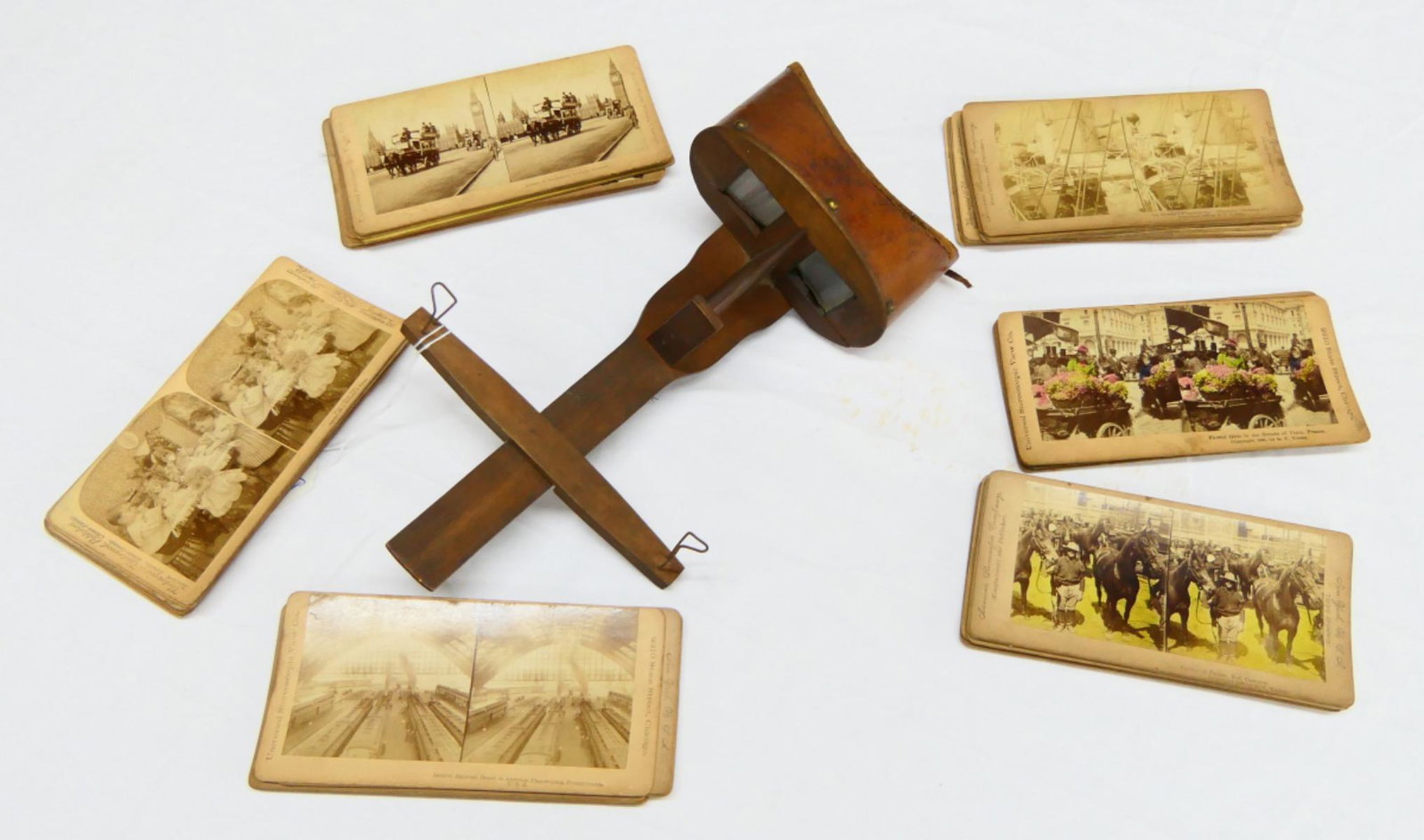 ANTIQUE WOODEN STEREOSCOPE SLIDE PICTURE VIEWER: Antique wooden stereoscope slide picture viewer with 49 card slides. Viewer measures approx. 13 1/2" length x 7 1/2" width (34.3cm x 19.1cm).
