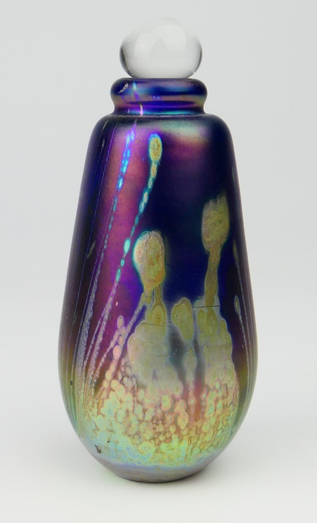 SIGNED VINTAGE ROBERT EICKHOLT IRIDESCENT BOTTLE: Robert Eickholt (AMERICAN, 20th Century) hand blown studio art glass perfume / scent bottle. Etched signature to bottom and dated 1982. Stopper does not appear original. Measures approx. 4 3/4" height
