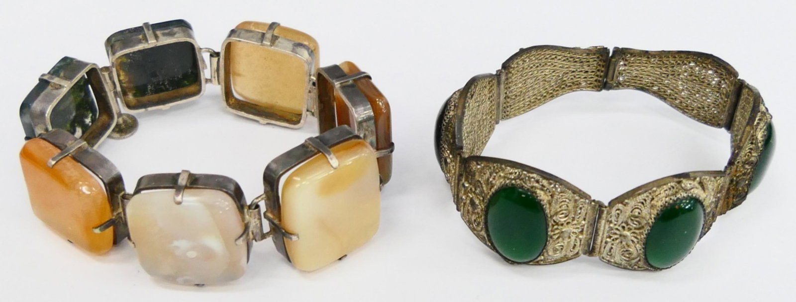 2 ASIAN ETHNIC SILVER AND STONE BRACELETS: Both about 7" in length, one with jade, the other with hard stones to include onyx, and carnelian. total weight of the 2 pieces 97 grams