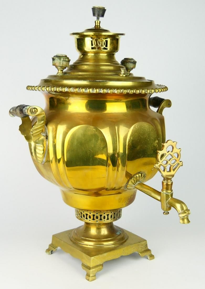 RUSSIAN HEAVY LARGE SIGNED ANTIQUE SAMOVAR: Double handled, with cup to top. Measures 21" tall, and 17" wide to end of spout. Incised maker, in the top in Russian. Handles are wooden, from a prominent Boca Raton Estate. .