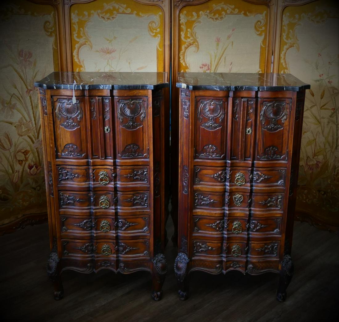 Pr FINE BELGIAN MARBLE TOP CARVED WOODEN CHESTS: A pair of very nicely carved Belgian walnut? wooden commode chests having ornate ribbon front French Regence design completed with original black marble tops. Retains partial kiln dried label to botto