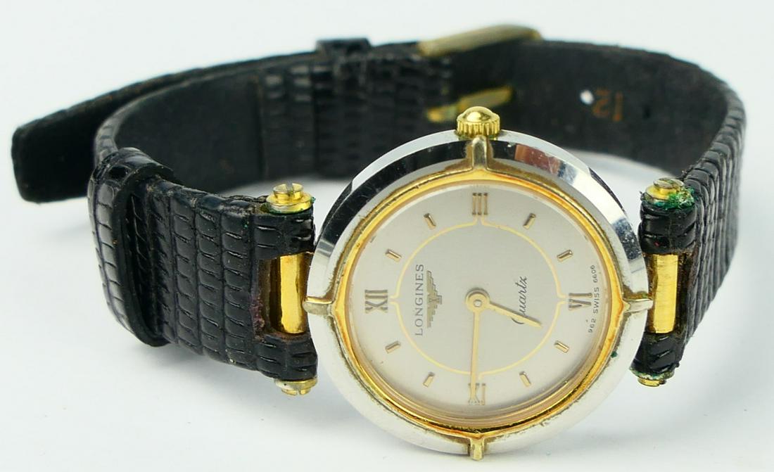 LONGINES LADIES QUARTZ WATCH: Small dial 3/4" wide . black leather strap. Serial number 21298484