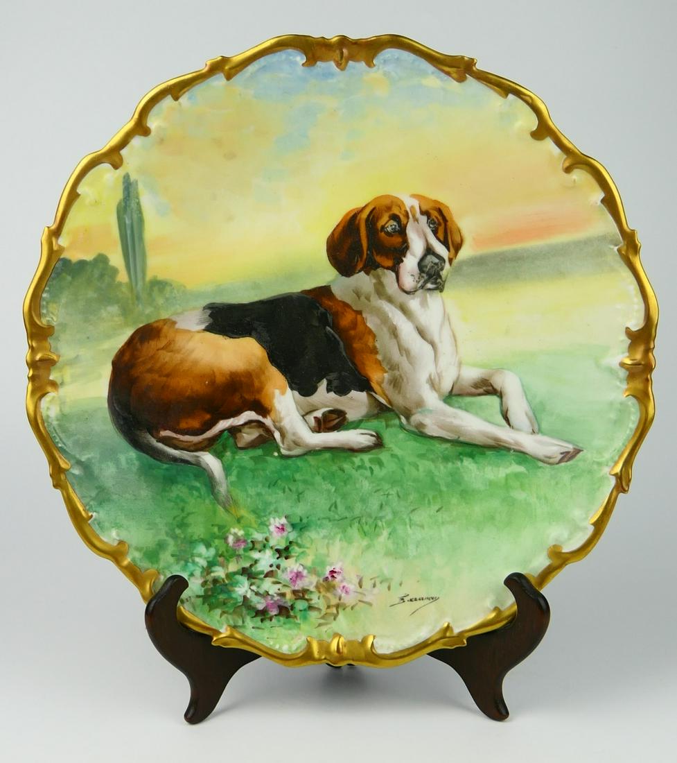 19TH CENTURY H.P. LIMOGES CHARGER OF A RESTING DOG: Measures 12" in diameter. L.R.L. Limoges company signed by the artist, circa 1890. Nice antique gold border.
