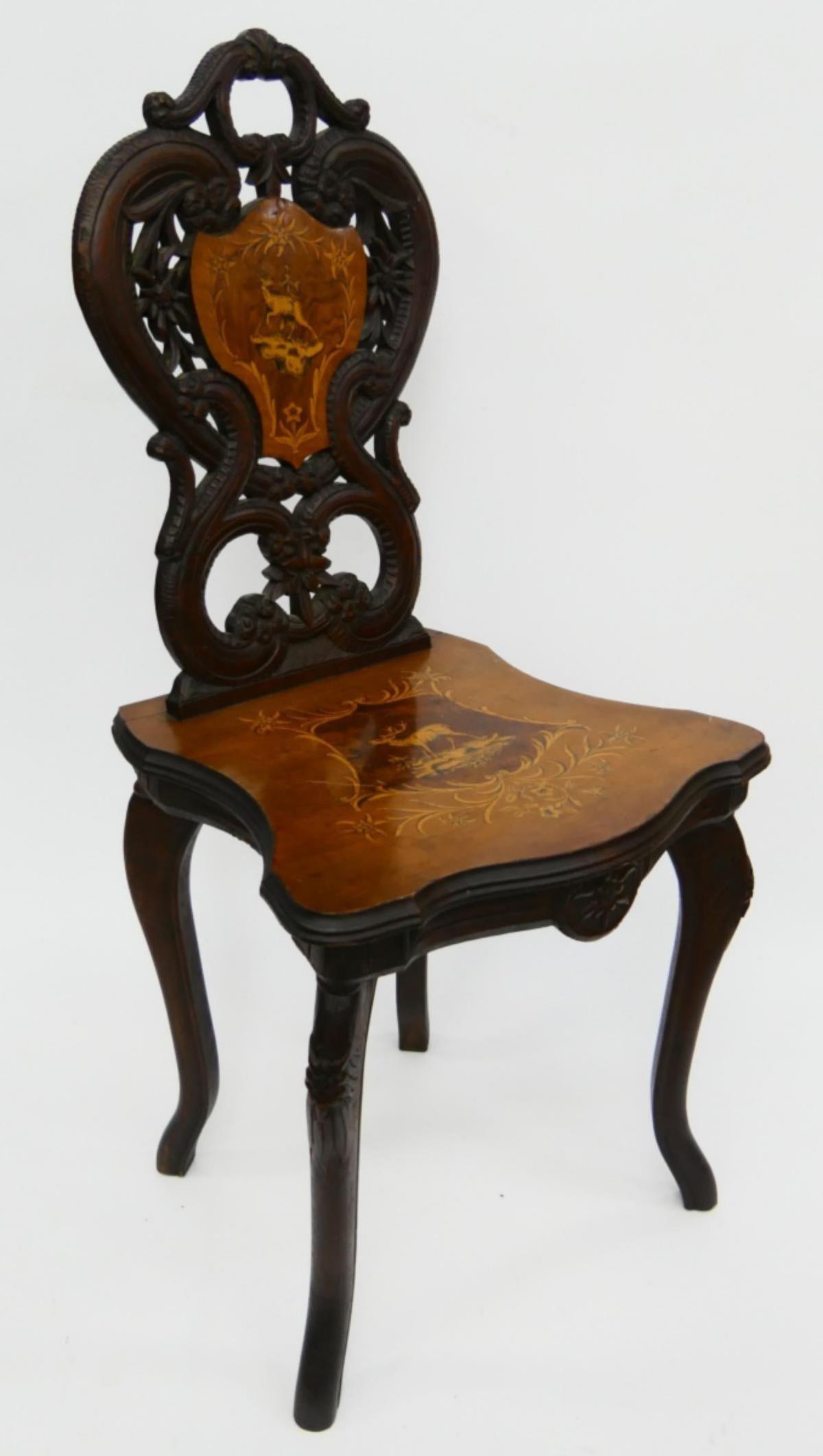 CARVED ANTIQUE ENGLISH MUSIC CHAIR MOOSE MOTIF: 19th century, all hand carved , decorated on lifted seat and back with Moose . English made for the Canadian market. Measures 34" tall, and about 18" wide.