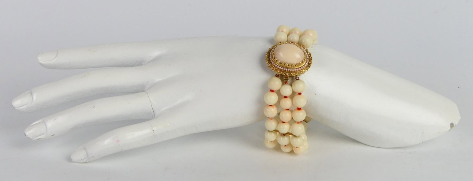 14K YELLOW GOLD ANGEL SKIN CORAL 3 STRAND BRACELET: A beautiful women's estate three strand beaded bracelet crafted of white angel skin coral in three strands; each bead approx. 11mm. Has ornate 14k yellow gold open box clasp with figure 8 safety featu