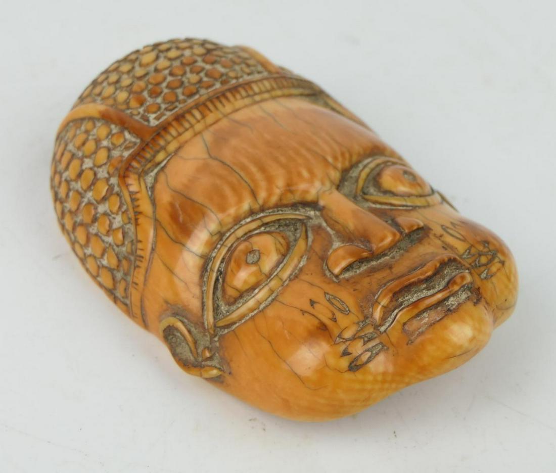 ANTIQUE THAI TIBETAN CARVED BONE BUDDHA PENDANT: Antique Thai / Tibetan carved tea stained bone large pendant depicting a Buddha face. Measures approx. Measures approx. 3 7/8" length x 2 1/2" width (9.8cm x 6.4cm). Total weight approx. 108 grams.