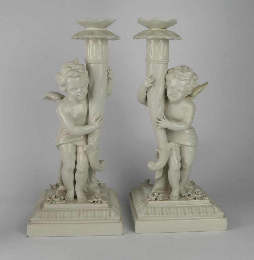PR. ANTIQUE ITALIAN PORCELAIN CHERUB TORCHIERES: Blanc de chine, probably turn of the last century, Victorian in age. Each measures 14 1/2" tall, mirrored images