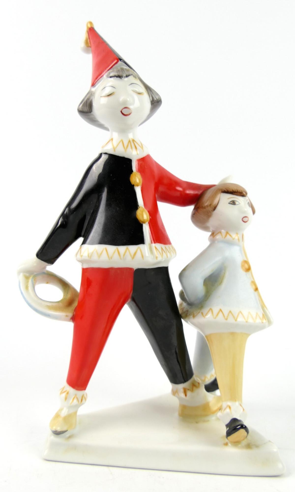 HOLLOHAZA HUNGARIAN PIERROT GROUP SCULPTURE: Vintage Hollohaza Hungarian hand painted porcelain sculpture depicting a pierrot clown group. Green hallmark to bottom. Measures approx. 8 1/2" height x 4" width.