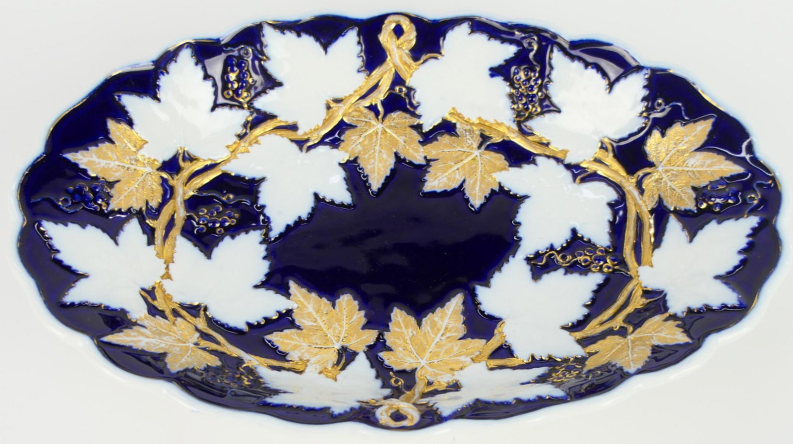 MEISSEN GOLD & COBALT FLORAL BOWL: Meissen gold and cobalt blue and floral leafs through out marked to bottom blue cross swords. Measures approx 11' long.