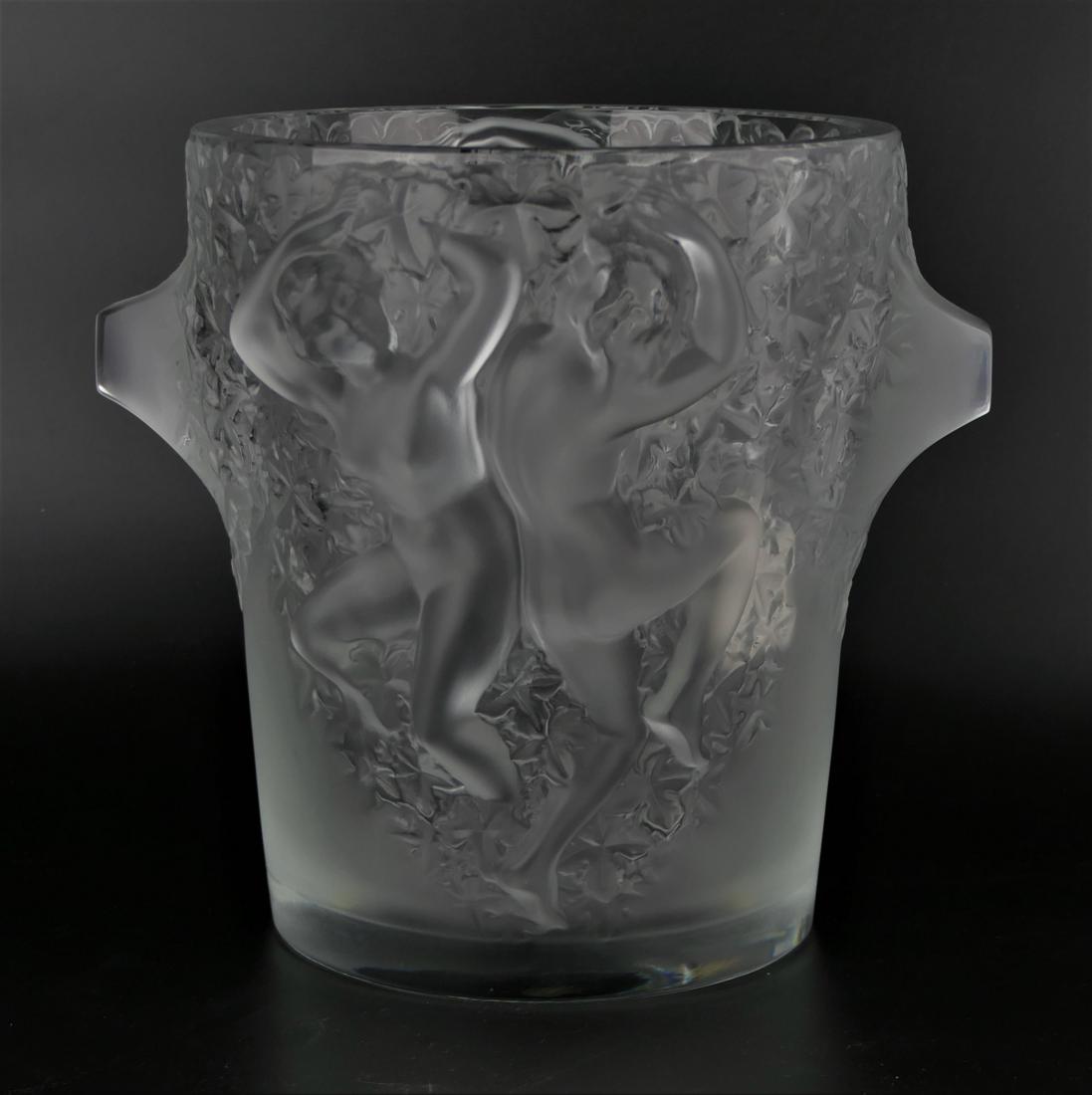 LALIQUE FRANCE CRYSTAL "GANYMEDE" NUDE ICE BUCKET: Lalique French crystal "Ganymede" champagne cooler / ice bucket having raised designs depicting dancing nude females. Signed "Lalique France" to side of base and retains factory label. Measures approx