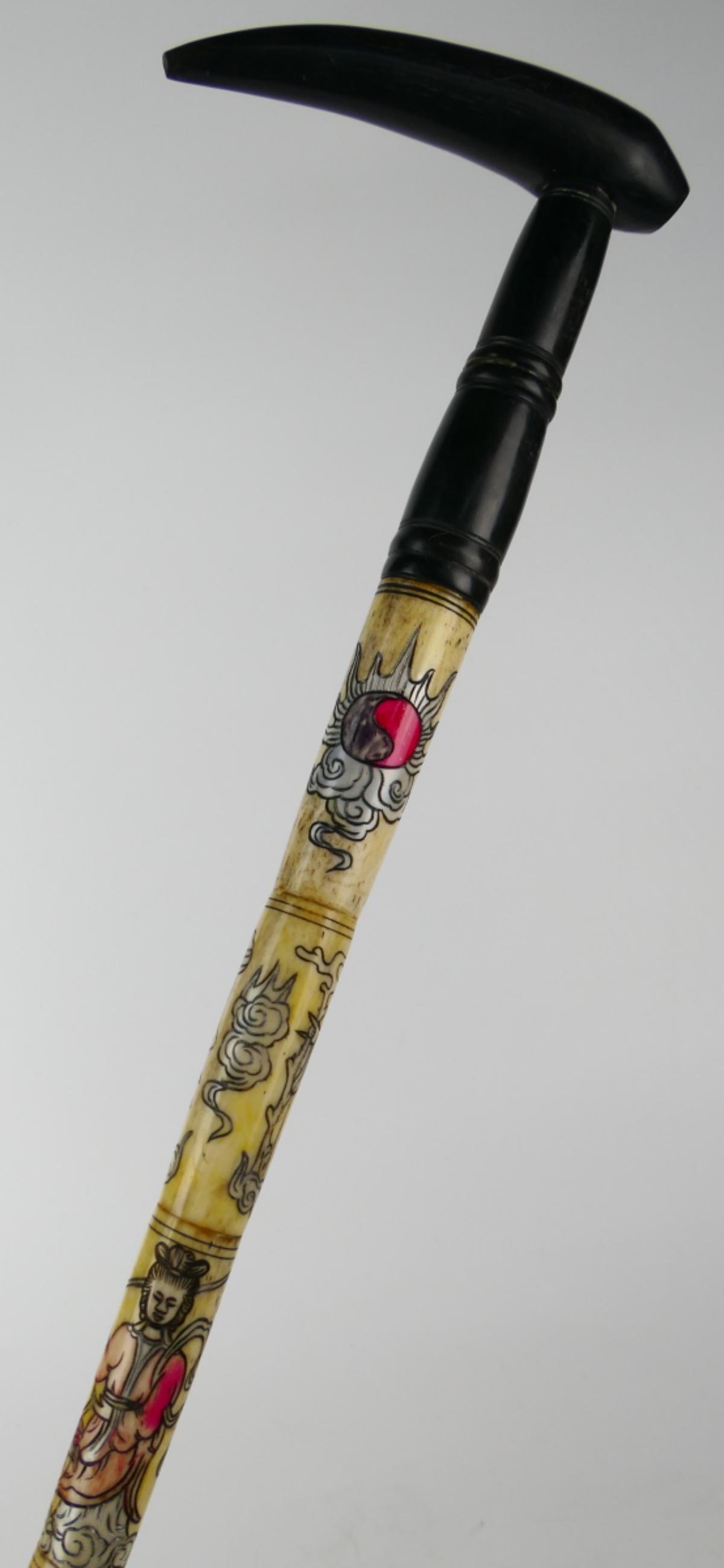 VINTAGE CHINESE POLYCHROME BONE 8 IMMORTALS CANE: Vintage, possibly antique, Chinese hand carved and polychrome bone walking cane depicting the Eight Immortals amongst clouds in stations along the shaft. Completed with polished horn handle. Measures