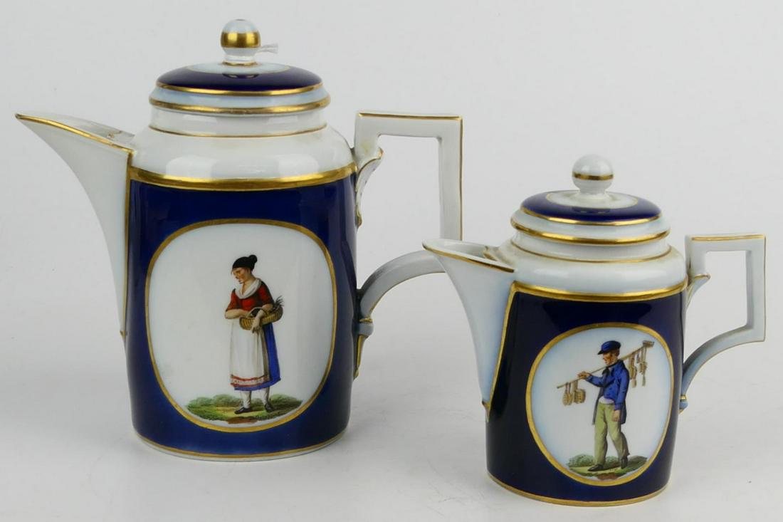 2 ANTIQUE BERLIN KPM PORCELAIN COVERED CREAMERS: A lot of two antique Berlin KPM hand painted porcelain graduating covered creamers. Each with with depictions of vendors, completed with cobalt ground and gold gilt accent. Each with blue underglaze s