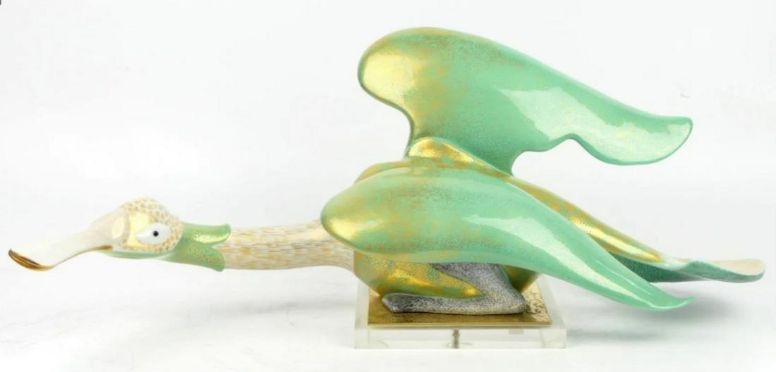 OGGETTI MANGANI LARGE PORCELAIN DUCK SCULPTURE: Oggetti Mangani Large Porcelain Duck Sculpture. Italy circa 1970. Hand-painted in 22k gold highlights. Mounted on Lucite base. 9"h. x 23" 1/2". OVERALL GOOD CONDITON.