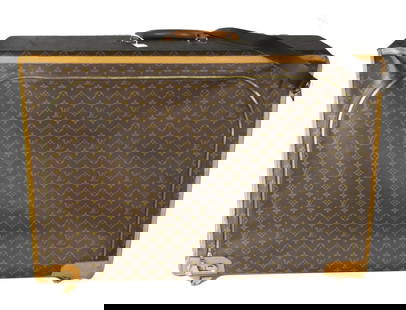 LOUIS VUITTON MONOGRAM LARGE SUITCASE: LV canvas monogram suitcase, lining, and panels, zipper closure with brass locking mechanism, fabric lined interior with straps. Measures approx 24" x 31".