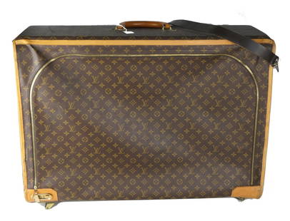 LOUIS VUITTON MONOGRAM LARGE SUITCASE: LV canvas monogram suitcase, lining, and panels, zipper closure with brass locking mechanism, fabric lined interior with straps. Measures approx 24" x 31".