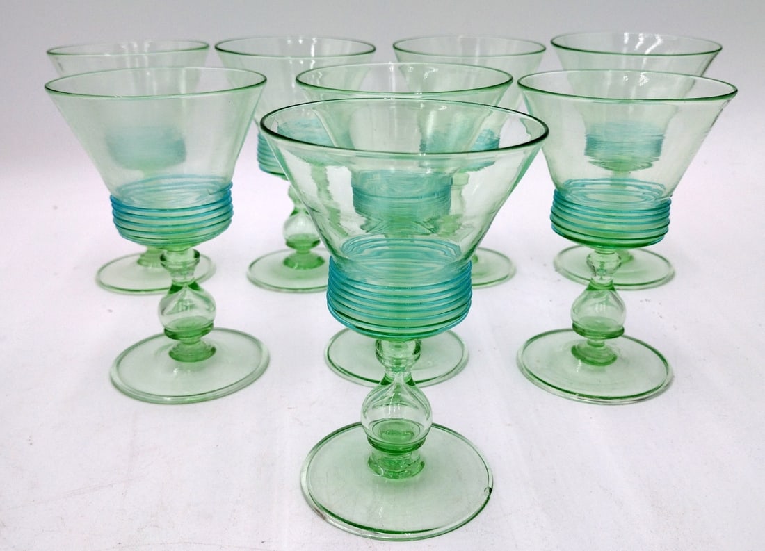 8 VENETIAN GLASS HAND BLOWN EMERALD GLASSES: A set of 8 Venetian Italian hand blown glass stemware wine glasses in a light emerald green tone. No apparent signatures. Each measures approx. 5 1/4" height x 3 1/2" diameter.