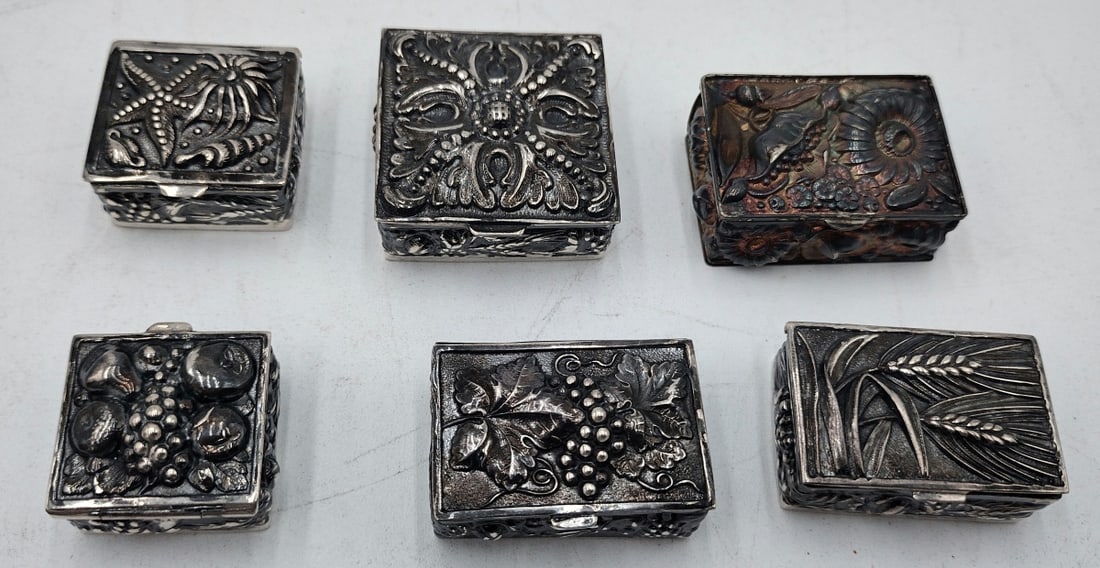 LOF 6 VINTAGE ANTIQUE STERLING SILVER PILL BOXES: A collection of 6 vintage, possibly antique, pill / snuff / trinket boxes crafted of sterling silver having repousse designs depicting grape clusters, sea life, wheat and flowers. Marked "925 SILVER".