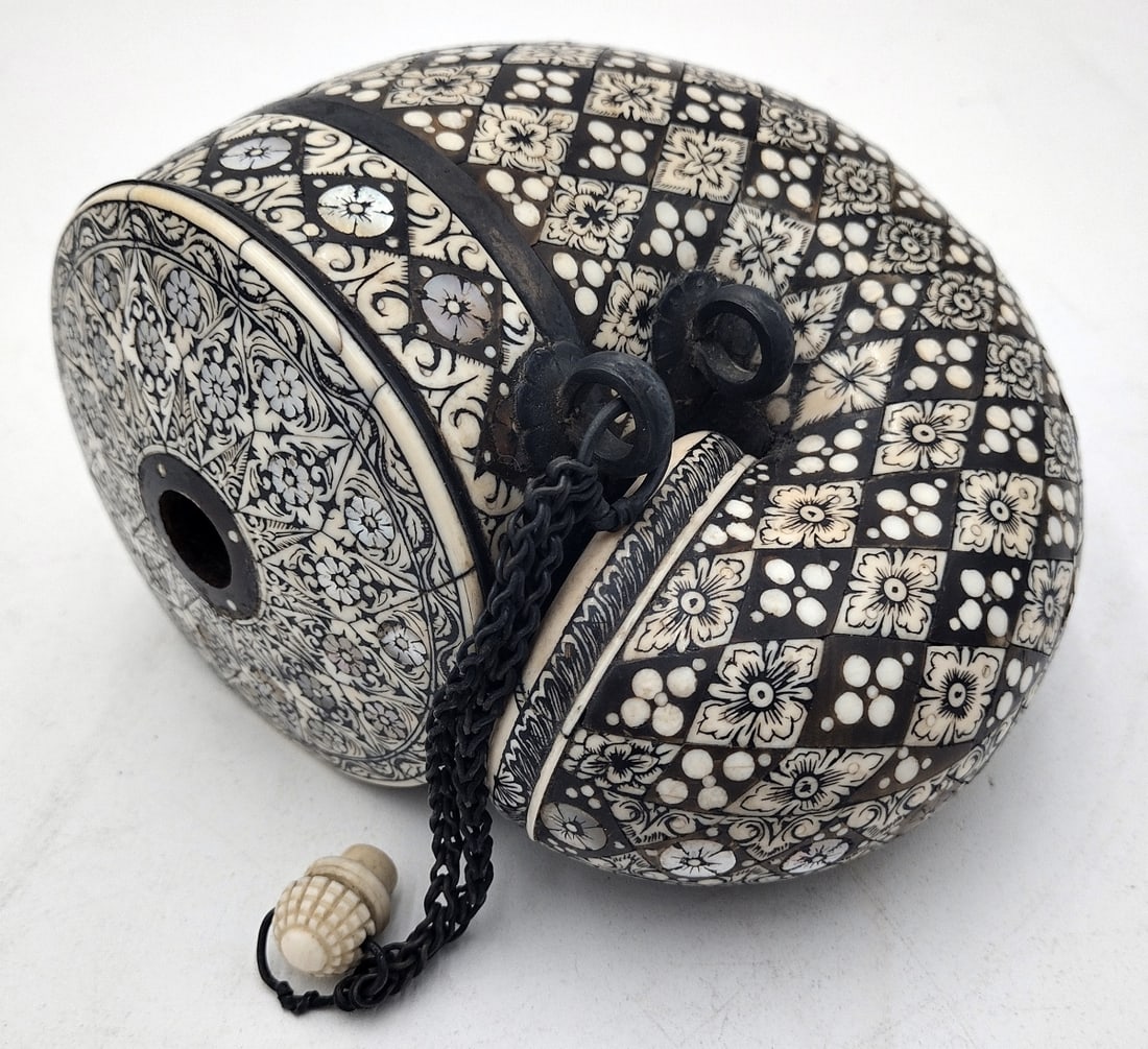 ANTIQUE MOROCCAN INLAID BONE GUN POWDER FLASK: Antique Moroccan or possibly Egyptian bone and mother of pearl inlaid intricate gunpowder flask horn. Completed with silver plated metal hardware. Measures approx. 5 1/2" height x 6" width x 3 3/4" de