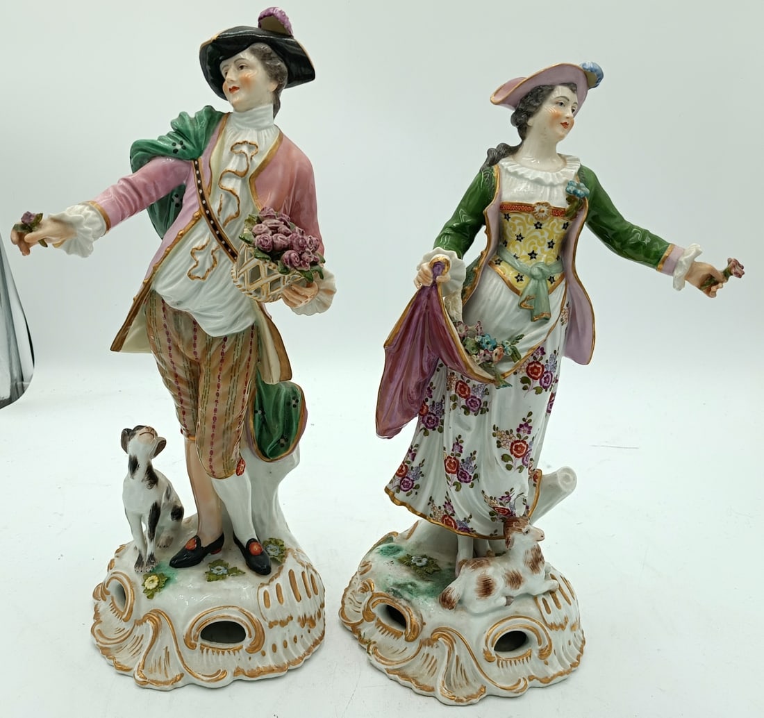 Pr MARX EUGENE CLAUSS FRANCE PORCELAIN FIGURES: A pair of antique Marx Eugene Clauss French porcelain figures depicting a man and woman with flowers, dog and lamb. Each with blue crossed swords marks to bottoms. Each measures approx. 14" height.