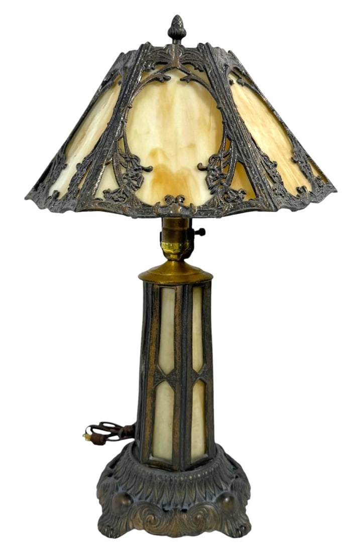 Vintage Cream Slag Glass Lamp: A vintage cream slag glass lamp featuring a beautifully ornate metalwork design. The lamp showcases a classic, elegant style with a cream-colored slag glass shade adorned with intricate metal filigree