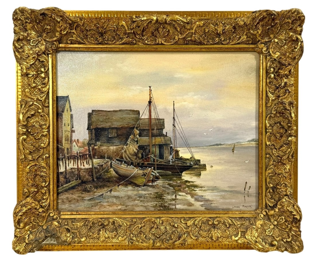 Laine Porter Harbor Scene Oil Painting: This oil painting by Laine Porter (20th century) features a serene harbor scene, depicting boats docked alongside rustic buildings under a calm sky. The painting captures the tranquil beauty of coasta