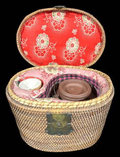 Chinese Yixing Zisha Teapot Set in a Woven Basket: This is a traditional Chinese Yixing Zisha teapot set, featuring a teapot and cup, housed in a beautifully crafted woven basket case. The teapot is made from Yixing clay, known for its porous nature,