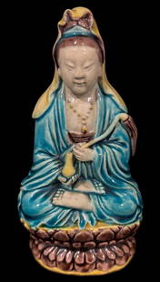 Chinese Hand Enameled Porcelain Guanyin Statue: A beautifully crafted Chinese porcelain statue depicting Guanyin, the Bodhisattva of Compassion. This piece is hand-enameled, showcasing vibrant colors such as blue, yellow, and brown. The statue feat
