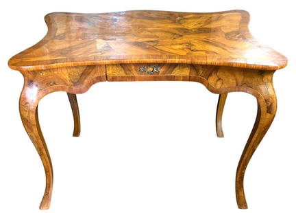 Antique Wood Carved Writing Desk: A beautifully crafted antique writing desk, likely from the Baroque period, featuring intricate wood veneer marquetry. The desk exhibits elegant cabriole legs and a unique serpentine shape, adding to