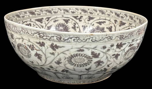 Chinese Porcelain Center Bowl w/ Christie's East Label: A large Chinese porcelain center bowl, intricately hand-painted with floral and vine motifs in a traditional style. The exterior features a detailed pattern of flowers and scrolling foliage, typical o
