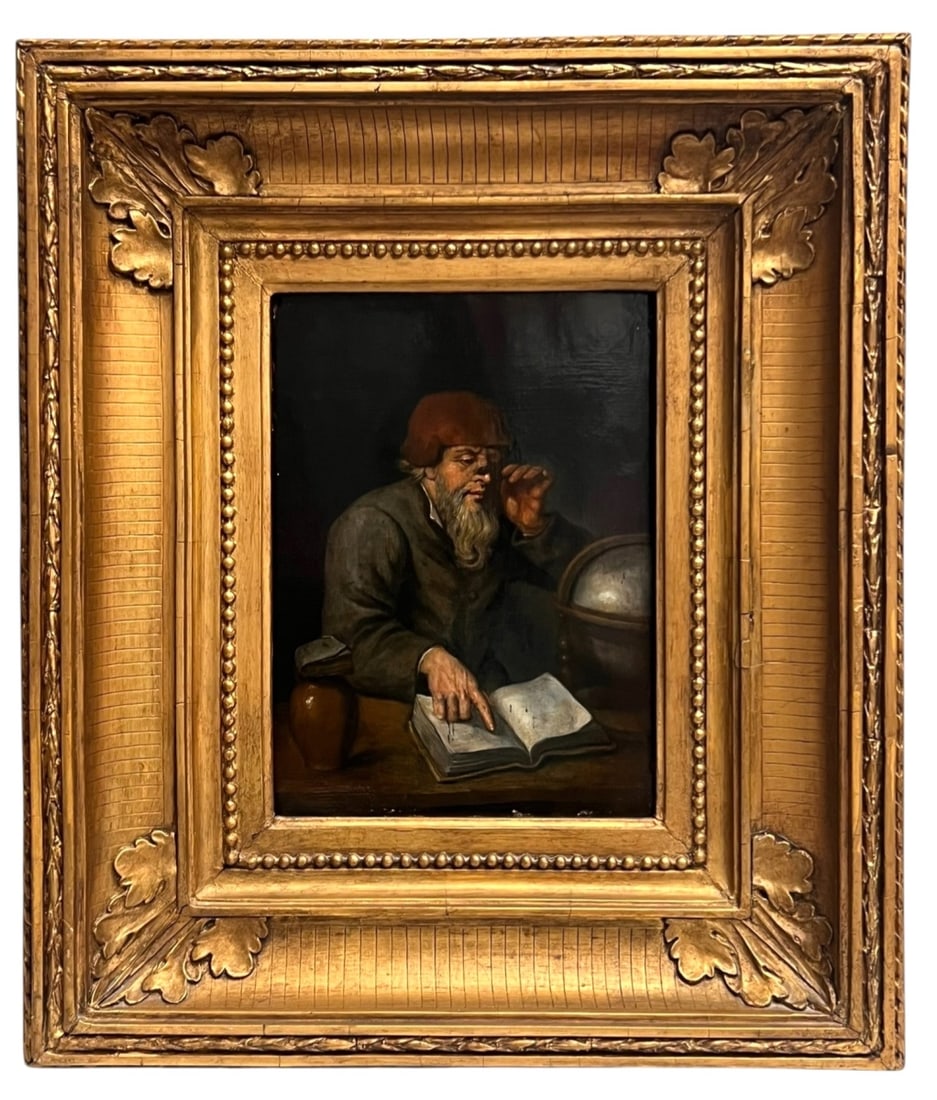 Antique Mystery Artist Signed Oil Painting: This captivating oil painting depicts an elderly man wearing a brown cap and a long beard, engrossed in reading a book with a globe beside him. The artwork is painted on board and is enclosed in an or