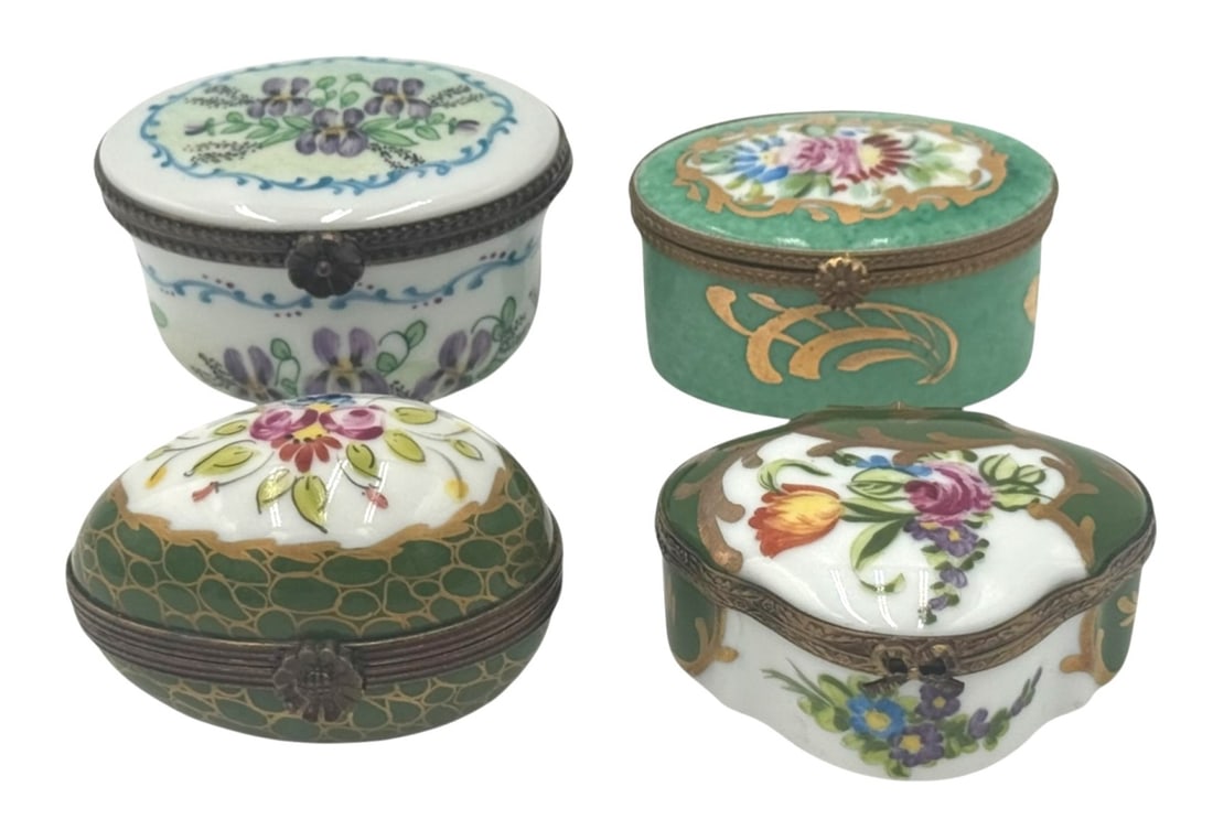 Limoges Hand-Painted Porcelain Pill Boxes: A set of four beautifully crafted, hand-painted porcelain pill boxes from Limoges, France. Each box features intricate floral designs and brass fittings that enhance their vintage charm. The boxes dis