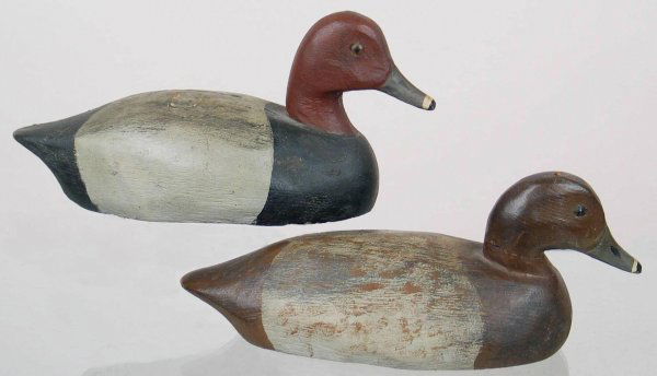 Pair of Mini Schmidt Redhead Decoys: Pair of mini redheads. Tight check (2 ½") and knot showing in upper body of drake. Left glass eye of drake is missing. Hen has nail in top of head visible. Provenance: William Moore collection