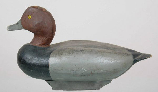 Redhead Drake Decoy: Hollow carved Illinois River style redhead. Bird has been reheaded. Body stylishly carved with wing and tail detail. Old paint shows light wear. Provenance: William Moore collection
