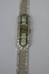 LADY'S ART DECO STYLE PLATINUM WATCH: THE CASE AND BRACELET ARE PLATINUM WITH A 14KT WHITE GOLD SAFETY CLASP--THE WATCH IS SET WITH 74 ROUND SINGLE CUT DIAMONDS WEIGHING 1.1 CARATS TOTAL WEIGHT AND 48 SQUARE/TRAPAZOID CUT FACETED GENUINE
