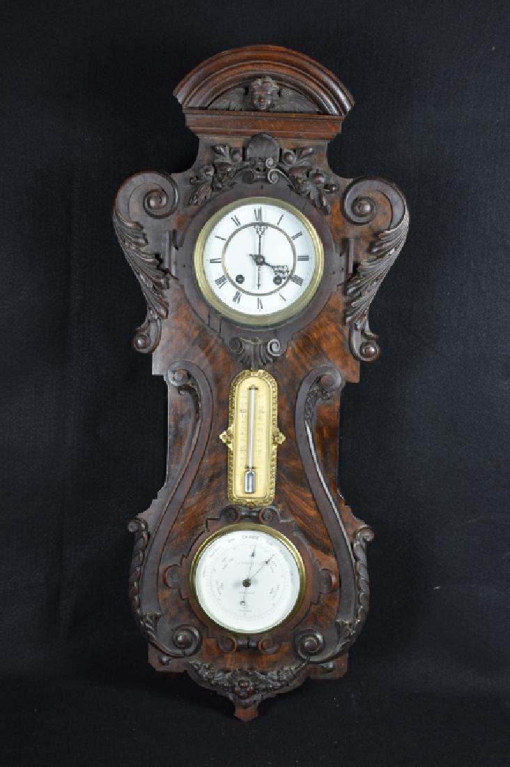 GERMAN CARVED WALL CLOCK WITH BAROMETER: 32" TALL--CLOCK IS BY J.J. WAINWRIGHT & CO. BIRMINGHAM--WORKS ARE BY LENZKIRCH--ALSO HAS A THERMOMETER--CLOCKS ARE SOLD ASIS WITH NO GUARANTEE OF WORKING CONDITION