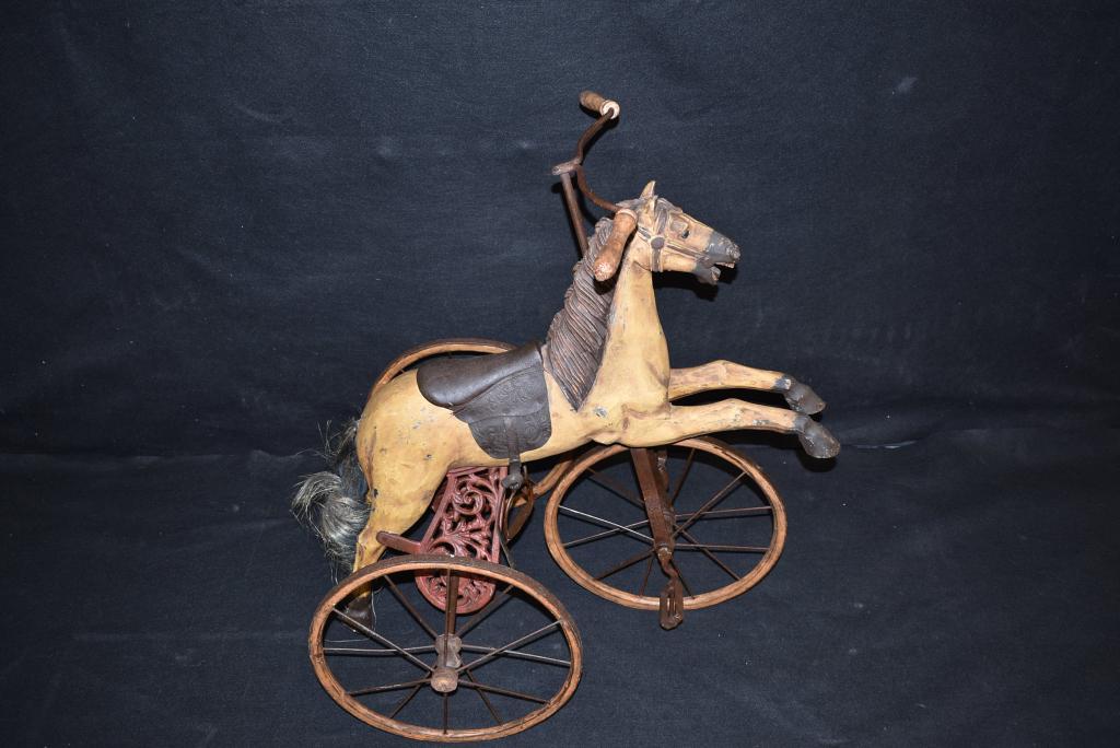 20TH C. HORSE TRICYCLE: CARVED WOOD HORSE W/ IRON STRAPPED -- WOOD WHEELS AND HAIR TAIL -- 33" TALL 16" DIAMETER WHEELS