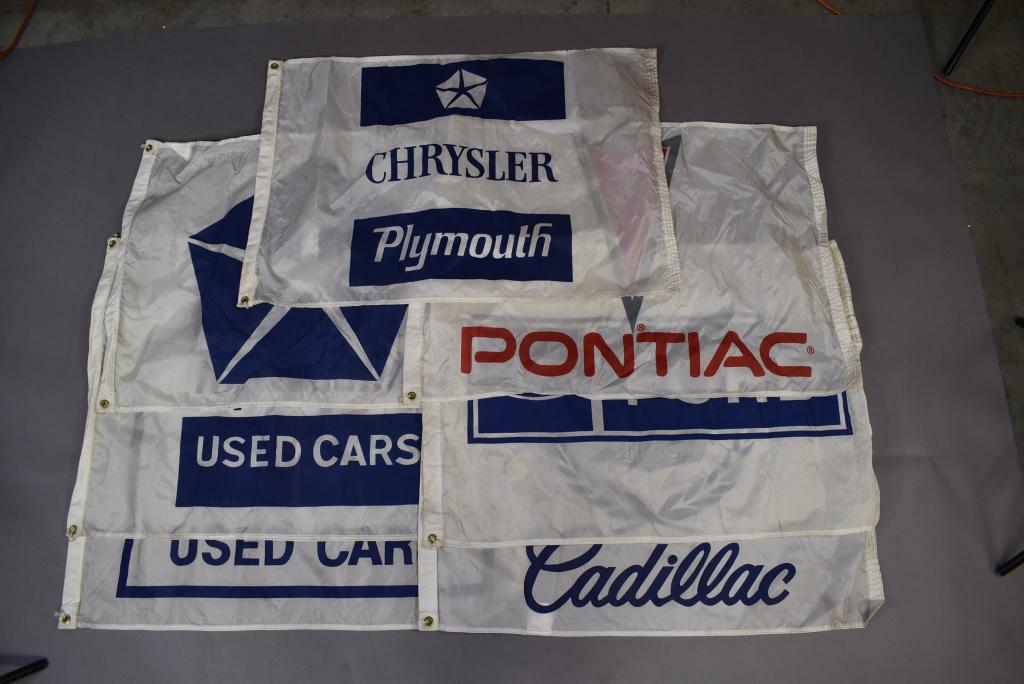 7 NYLON DEALER FLAGS: 3 CHRYSLER -- 1 FORD -- 1 CADILLAC -- 1 PONTIAC -- 1 CHEVROLET