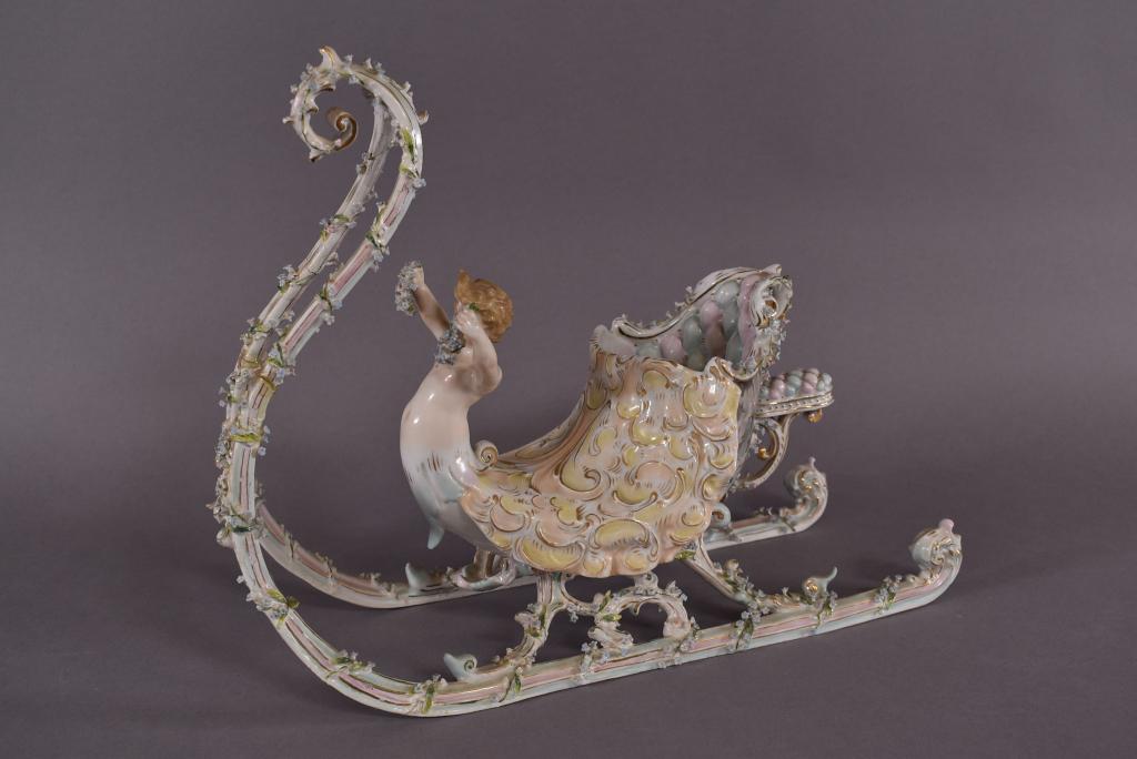 MEISSEN STYLE PORCELAIN SLEIGH WITH CHERUB: 15 1/2" X 5 3/4" X 11 1/2"--HAS BEEN REPAIRED MULTIPLE PLACES (SEE PHOTOS)