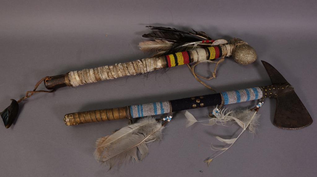 2 NATIVE AMERICAN BEADED HATCHETS: STONE ONE IS 22" LONG--IRON ONE IS 23" LONG--LEATHER & FEATHER DECORATED